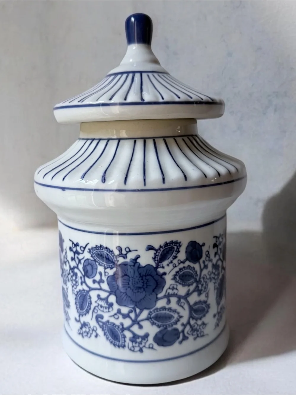 Asian- Chinoiserie floral body paired with a striped pagoda roof lid canister